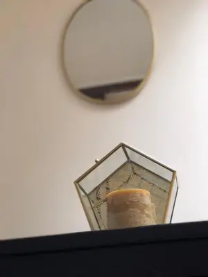 a mirror sitting on top of a table with a candle at Absolute Charm 3 Bedroom 3 Bathroom with AC EU District in Brussels