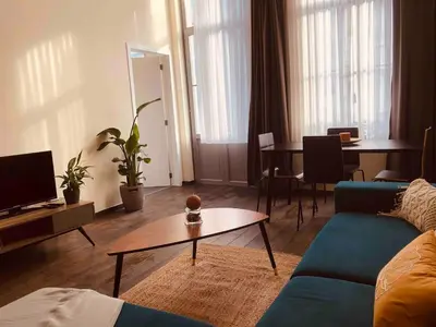 a living room with a couch and a table at Cosy 1 bedroom apartment in EU DISTRICT in Brussels