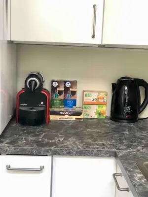 a kitchen counter with a coffee pot and books on it at Cosy 1 bedroom apartment in EU DISTRICT in Brussels
