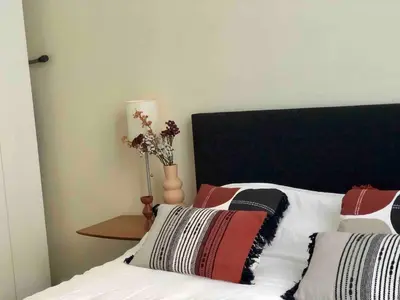 a bedroom with a bed with two pillows and a lamp at Cosy 1 bedroom apartment in EU DISTRICT in Brussels