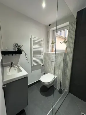 a bathroom with a toilet and a glass shower at Ixelles - Cozy studio in middle of European District in Brussels