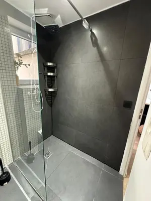 a shower with a glass door in a bathroom at Ixelles - Cozy studio in middle of European District in Brussels