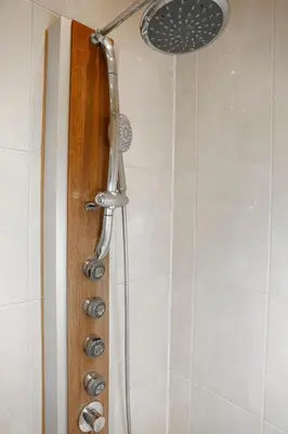 a shower with a shower head in a bathroom at Appartement, deux chambres au pied du métro Montgomery in Brussels