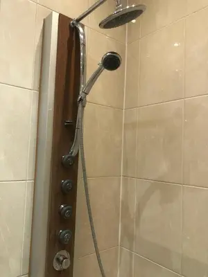a shower with a shower head in a bathroom at Appartement, deux chambres au pied du métro Montgomery in Brussels