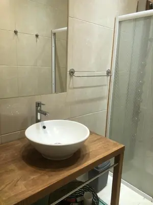 a bathroom with a white sink and a shower at Appartement, deux chambres au pied du métro Montgomery in Brussels