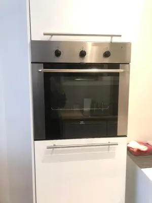 a kitchen with an oven in a white kitchen at Appartement, deux chambres au pied du métro Montgomery in Brussels