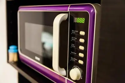 a purple microwave oven sitting on a shelf at ETTERBEEK - Sunny loft Studio - EU AREA in Brussels