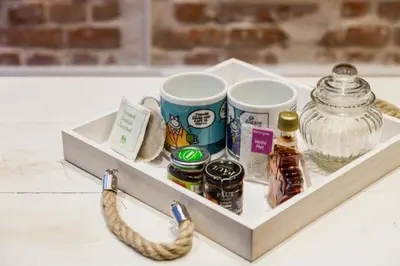 a tray with two coffee cups and a jar of spices at ETTERBEEK - Sunny loft Studio - EU AREA in Brussels