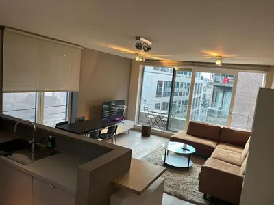 a living room with a couch and a table at Comfortable Two bedroom Apartment in City Center in Brussels