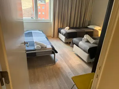 a small room with two beds and a window at Comfortable Two bedroom Apartment in City Center in Brussels