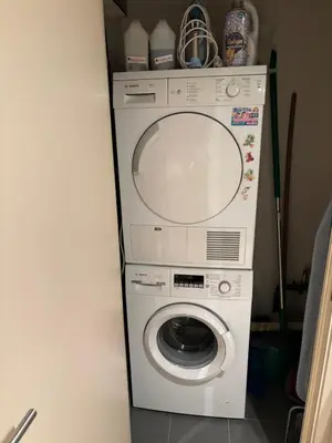 a washer and dryer in a corner of a room at Comfortable Two bedroom Apartment in City Center in Brussels