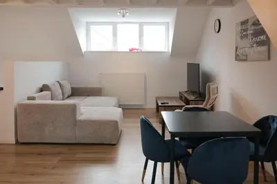 a living room with a couch and a table and chairs at Blu shell house in Brussels