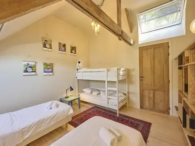 a bedroom with two bunk beds and a window at Villa Lactea in Schilde