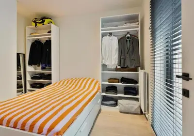 a bedroom with a bed and a closet at 1BR apartment by Central Station in Antwerp