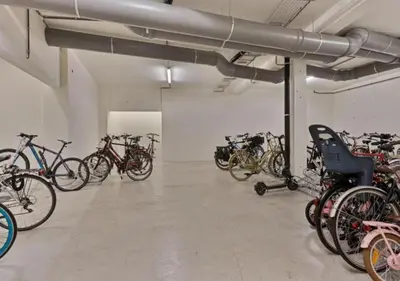 a room with a bunch of bikes parked in it at 1BR apartment by Central Station in Antwerp