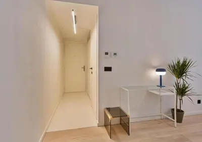 a hallway with white walls and a white door at 1BR apartment by Central Station in Antwerp