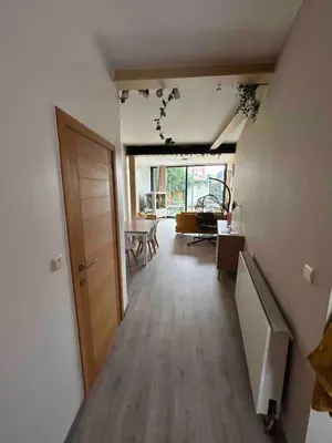 a room with a hallway with a door and a living room at SiSEL HOUSE avaible with garden for 6 or more people! in Temse