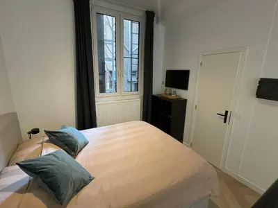 a bedroom with a bed with two pillows on it at Stadsstudio Antwerpen in Antwerp