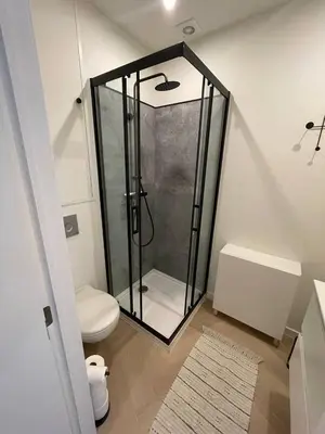 a bathroom with a shower and a toilet at Stadsstudio Antwerpen in Antwerp