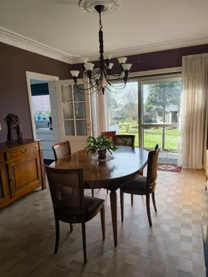 a dining room with a wooden table and chairs at Spelaan in Zottegem