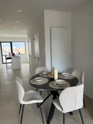 a dining room with a black table and chairs at Luxury Duplex near Expo 12 & ING Arena & Atomium in Wemmel