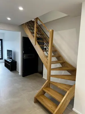 a wooden staircase in a living room at Luxury Duplex near Expo 12 & ING Arena & Atomium in Wemmel