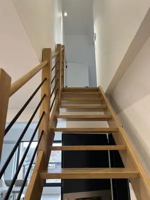a stairwell in a house with wooden stairs at Luxury Duplex near Expo 12 & ING Arena & Atomium in Wemmel
