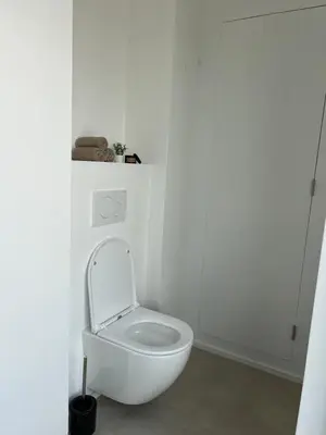 a white bathroom with a toilet in a room at Luxury Duplex near Expo 12 & ING Arena & Atomium in Wemmel