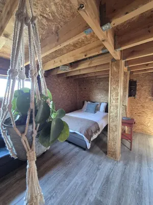 a swinging bed in a room with a wooden ceiling at 't Spoor Berlaar in Berlaar