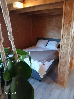 a bed in a room with a swing at 't Spoor Berlaar in Berlaar
