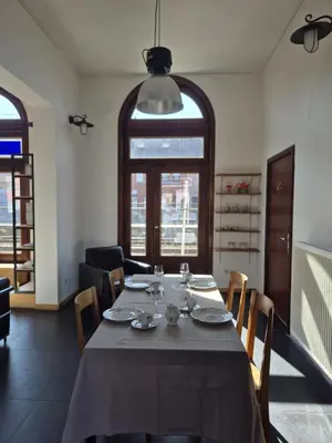 a dining room with a table with plates and wine glasses at 't Spoor Berlaar in Berlaar
