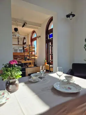 a table with two plates and glasses on it at 't Spoor Berlaar in Berlaar