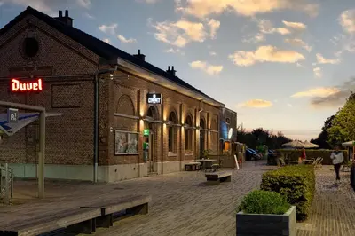 a brick building with a sign on the side of it at 't Spoor Berlaar in Berlaar