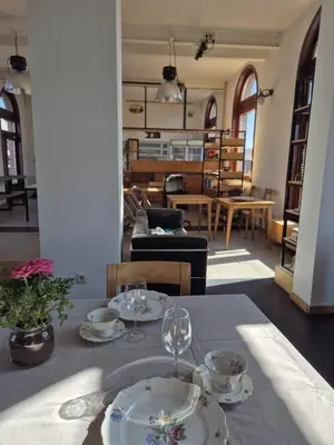 a table with two plates and wine glasses on it at 't Spoor Berlaar in Berlaar