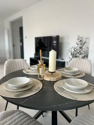 a black table with plates and a candle on it at Luxury Apartment near Expo 12 & ING Arena & Atomium in Wemmel