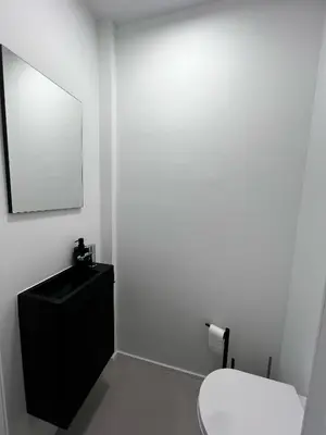 a bathroom with a toilet and a sink and a mirror at Luxury Apartment near Expo 12 & ING Arena & Atomium in Wemmel