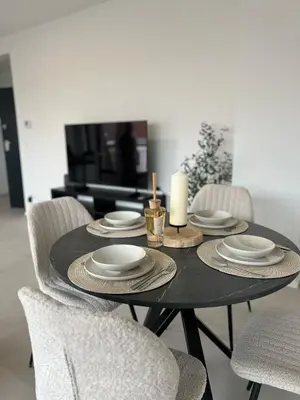 a black table with a candle and plates and chairs at Luxury Apartment near Expo 12 & ING Arena & Atomium in Wemmel