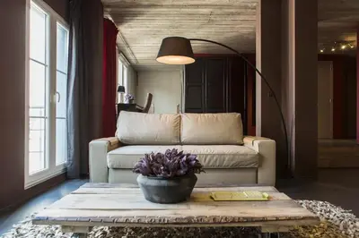 a living room with a couch and a table at Lux Loft in the heart of Historic Antwerp in Antwerp