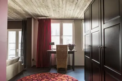 a room with a table and a window at Lux Loft in the heart of Historic Antwerp in Antwerp