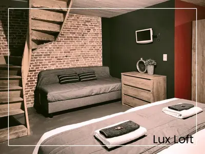 a bedroom with a bed and a brick wall at Lux Loft in the heart of Historic Antwerp in Antwerp