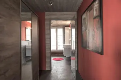 a bathroom with red walls and a red wall at Lux Loft in the heart of Historic Antwerp in Antwerp