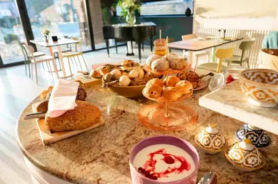 a table with a bunch of pastries and desserts on it at Logies La Mairie in Waterland-Oudeman