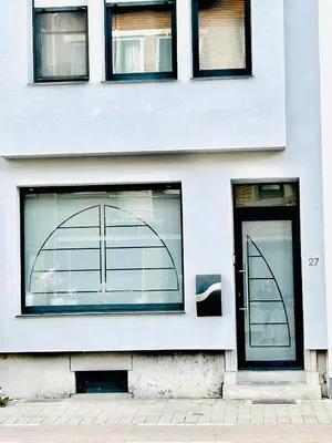 a white building with windows and a door at The Nest In Leuven - Family Friendly Room in Leuven