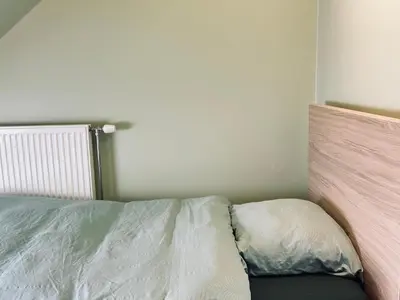 a bedroom with a bed with a pillow on it at The Nest In Leuven - Family Friendly Room in Leuven