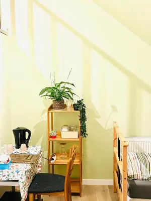 a dining room with a table and a chair and a table and a tableablish at The Nest In Leuven - Family Friendly Room in Leuven