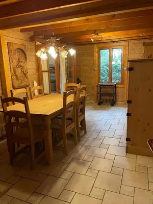 a dining room with a wooden table and chairs at De Reinakker Bungalow in Sint-Gillis-Waas