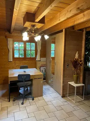 a kitchen with a desk and a chair in a room at De Reinakker Bungalow in Sint-Gillis-Waas