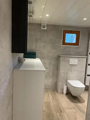 a bathroom with a sink and a toilet in it at De Reinakker Bungalow in Sint-Gillis-Waas