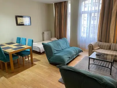 a living room with a couch and a table at Bourse Grand Place in Brussels