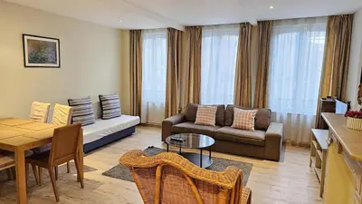 a living room with a couch and a table at Bourse Grand Place in Brussels